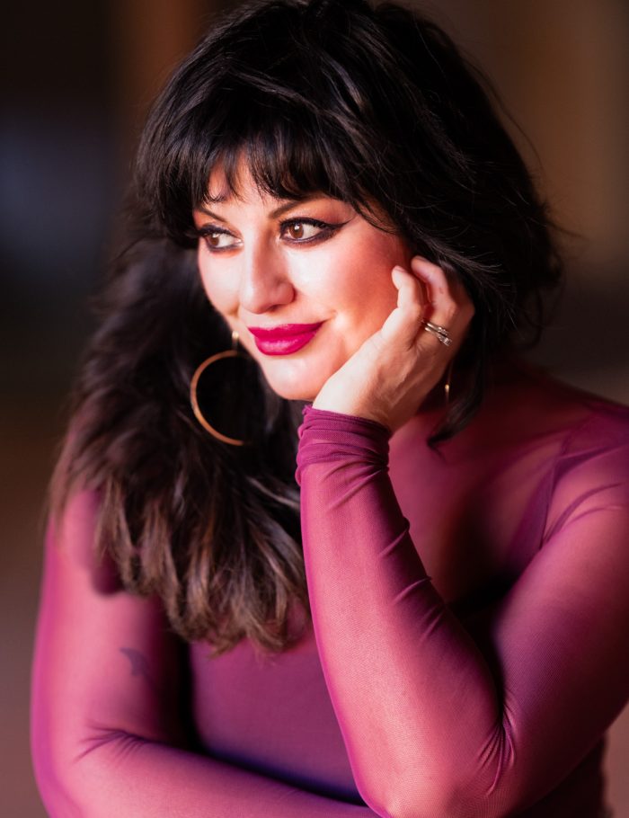 Portrait of Bleu Briggs photographer in a burgundy blouse for glamour architects.